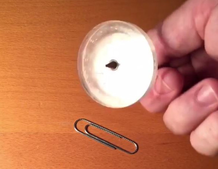 We can't stop watching this paperclip spin around a top.