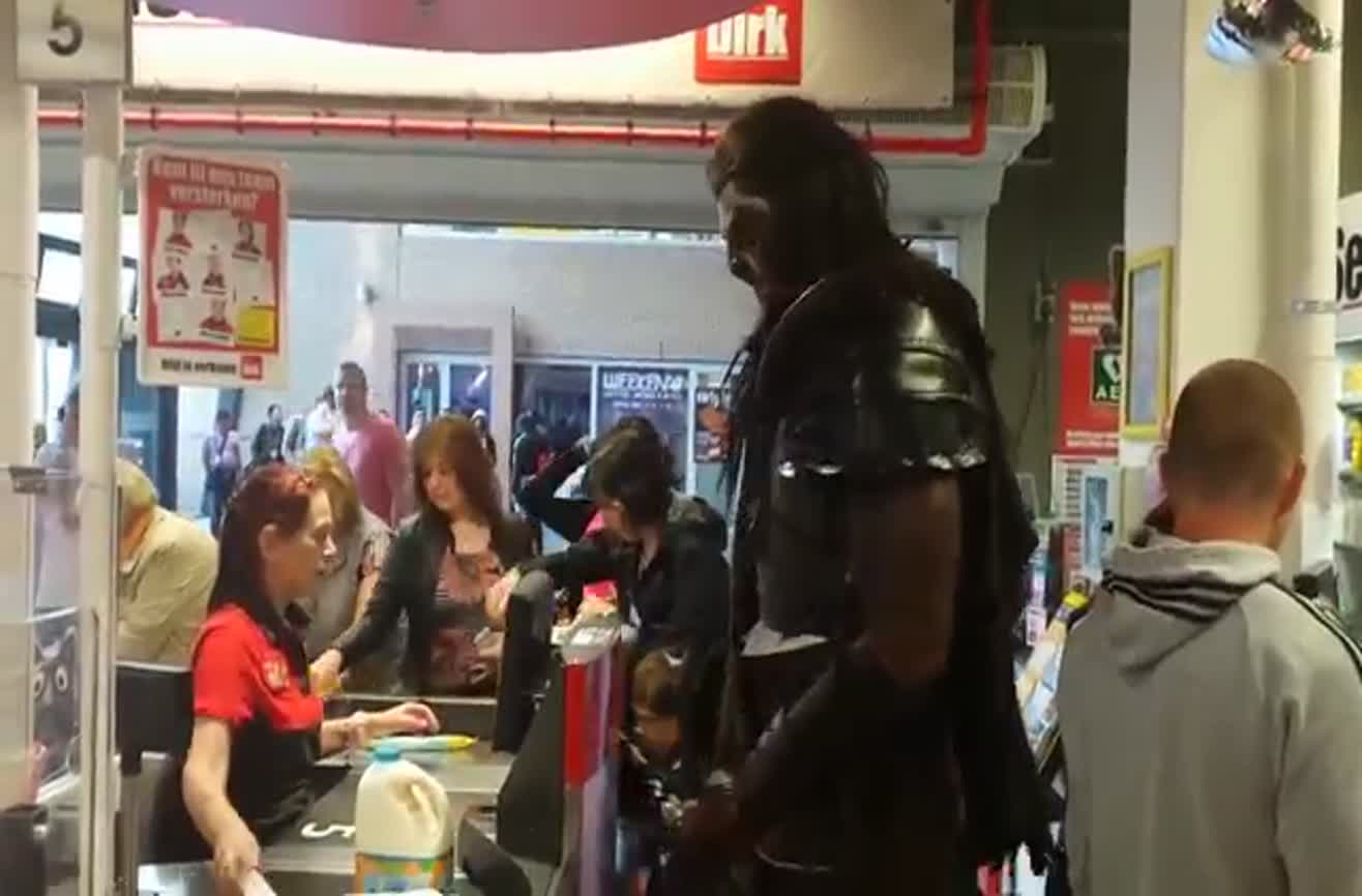 A seven-foot tall man goes shopping dressed as an Uruk-hai.
