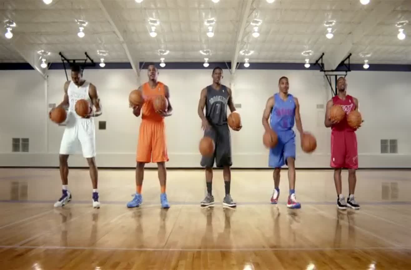 NBA players create a Christmas carol by dribbling basketballs in rhythm.