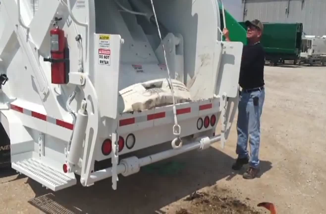 How strong is a garbage truck's compactor?