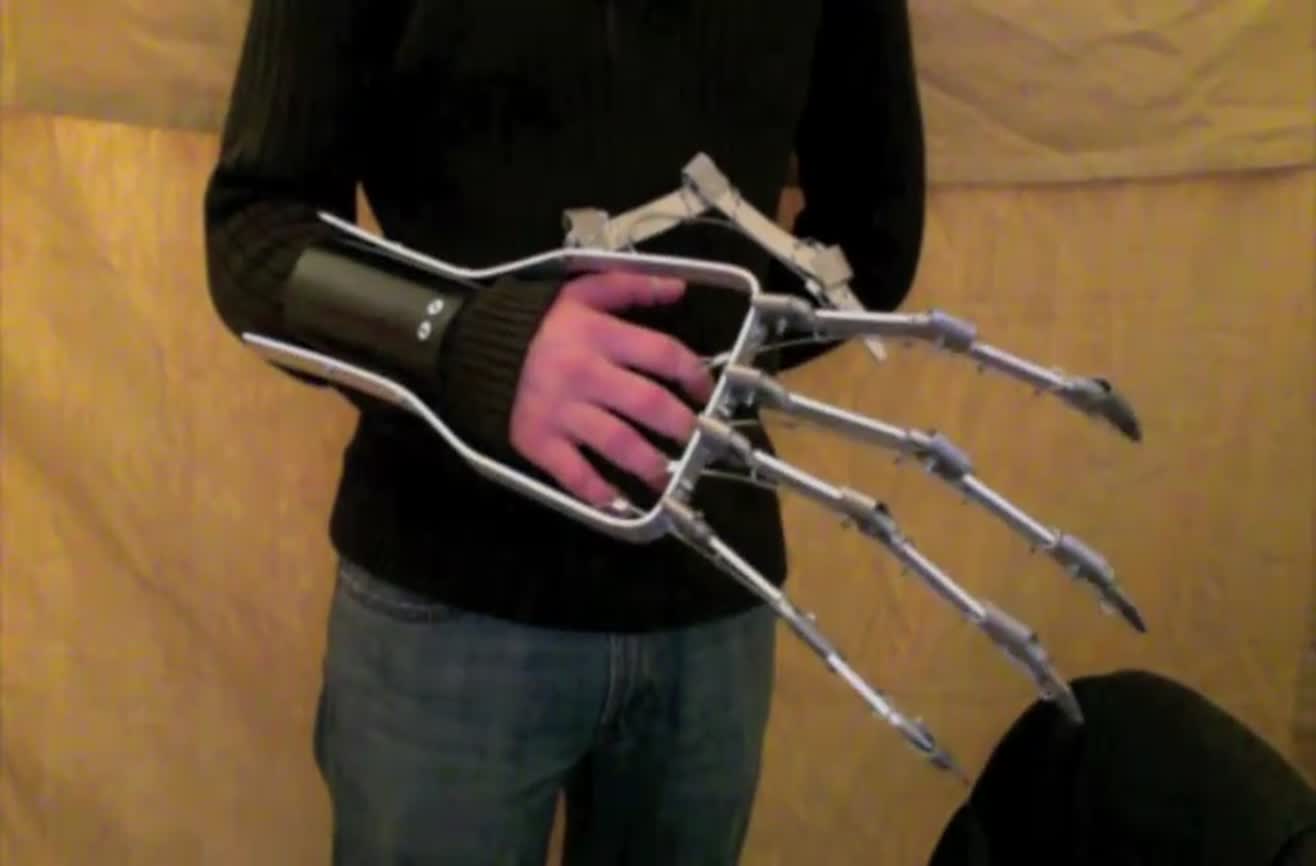 Large mechanical hand mimics the movements of the wearer's hand.