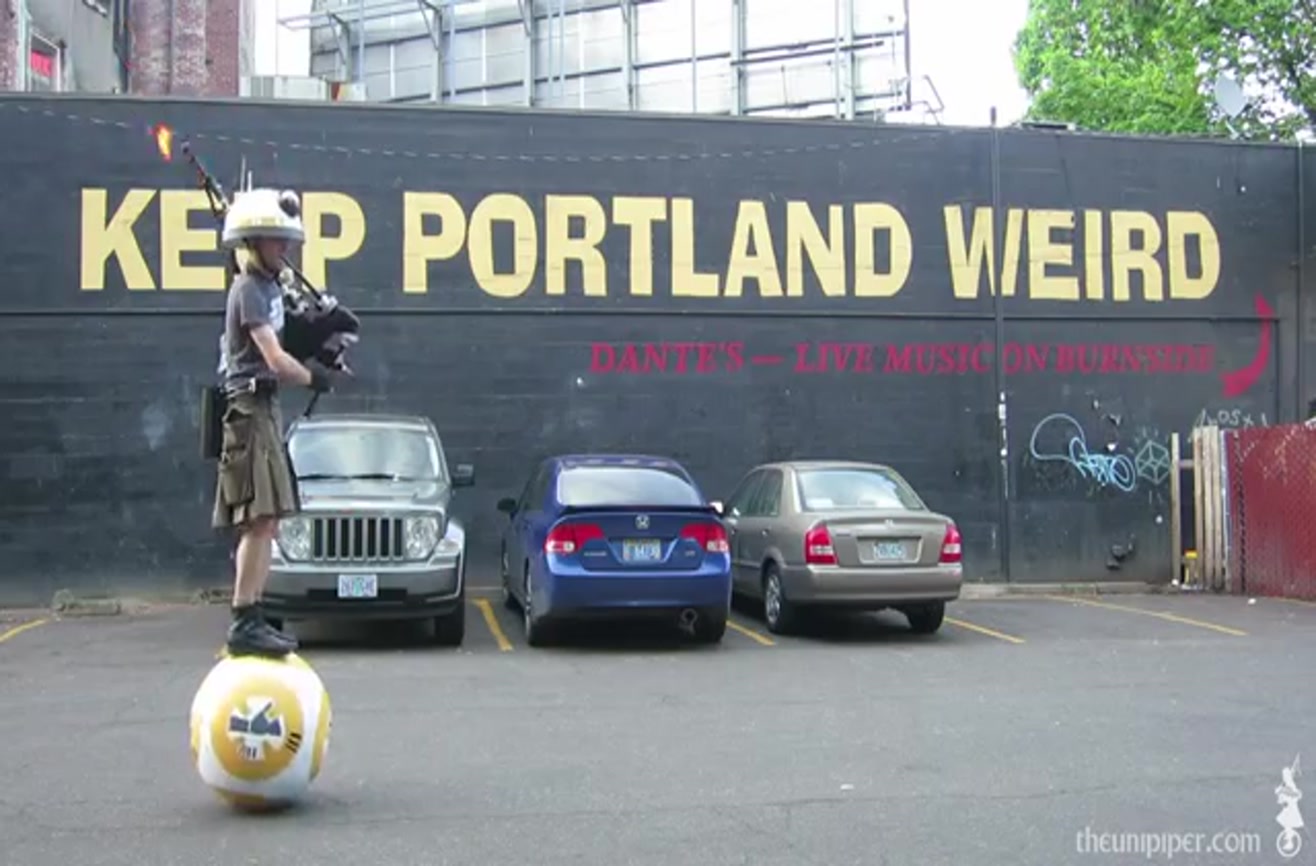 Man balances on droid and plays the "Star Wars" theme song on flame