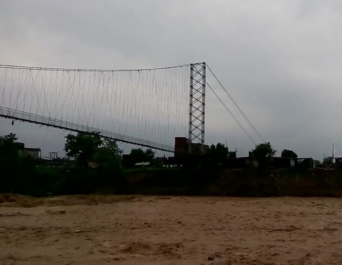 Suspension bridge collapses during a massive flood.