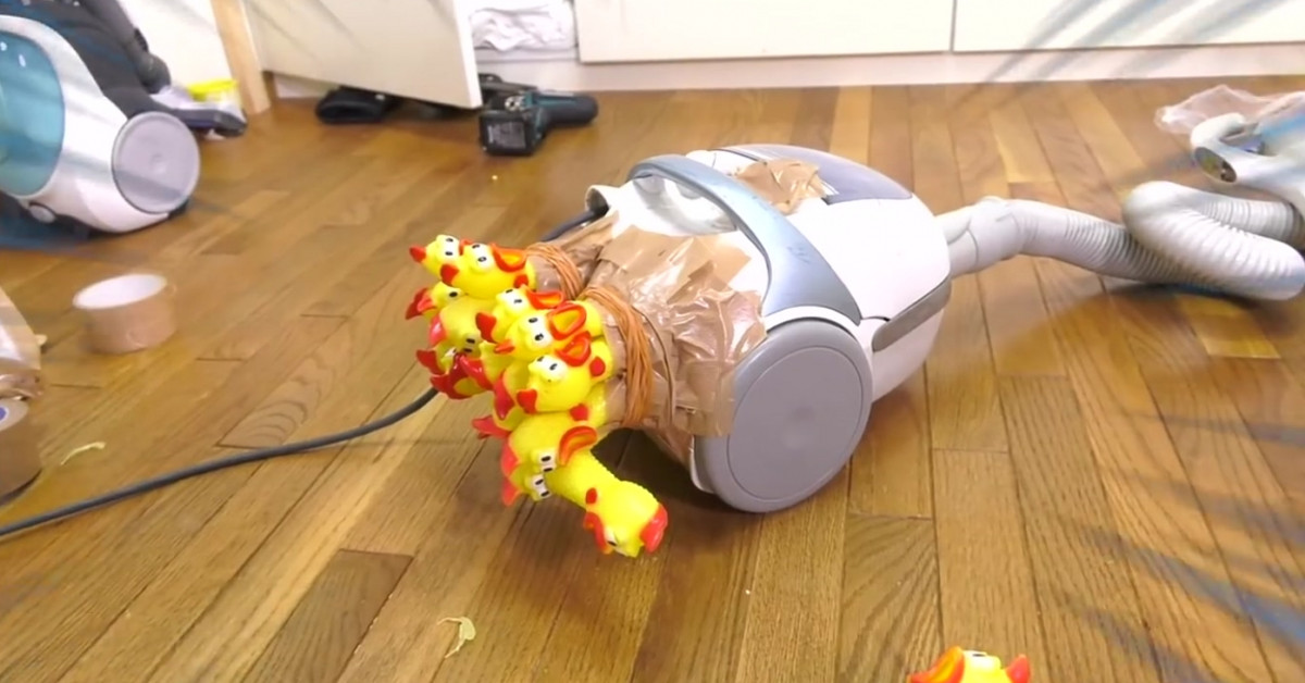Guy attaches as many screaming rubber chickens to his vacuum cleaner as