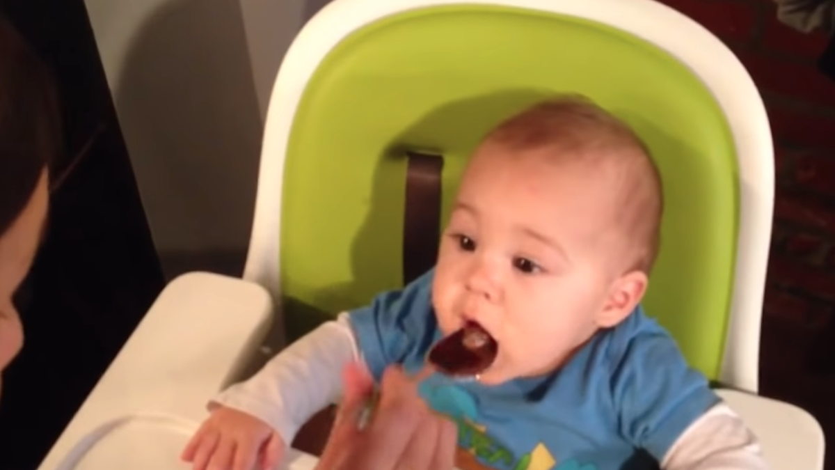 Baby tastes chocolate for the first time