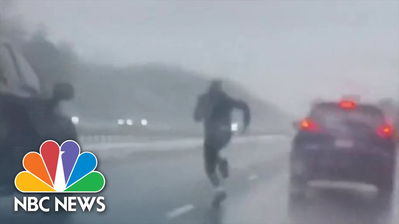 Man runs across highway to save distressed driver.